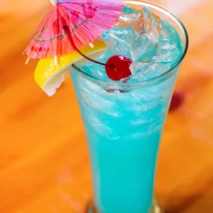 a blue drink with an umbrella