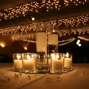 a table with candles and glass vases