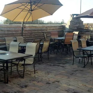 a patio with tables and umbrellas