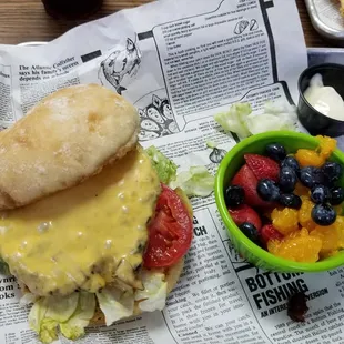 Cheeseburger and a side of fruit.