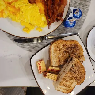 Two egg breakfasts include bacon , eggs, and sourdough toast.