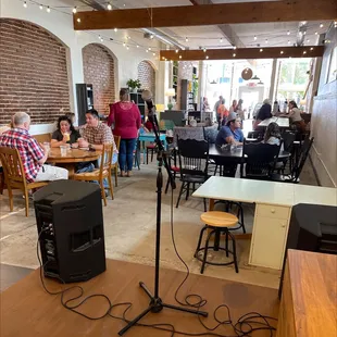 people sitting at tables and a microphone