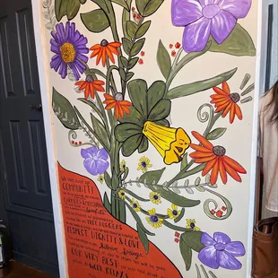 a woman standing in front of a poster