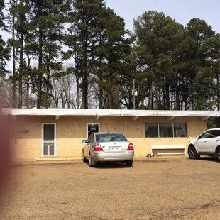 two cars parked in front of a building
