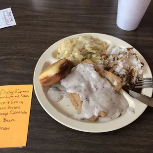 a plate of food with gravy and bread