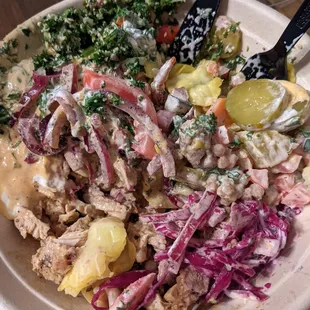 Chicken shawarma bowl with israeli couscous base and many of the toppings.