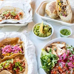 a variety of tacos and salads