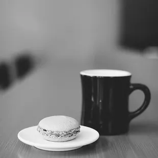 a cup of coffee and a macaron