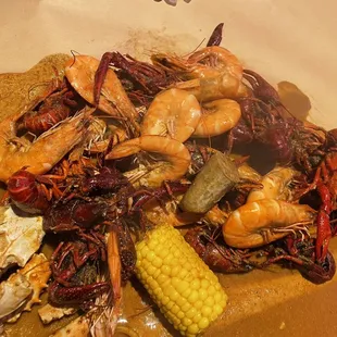 Mix of shrimp, crawfish, sausage, and corn in the Cajun sauce, 3 stars. Flavors out of this world amazing. Would recommend!