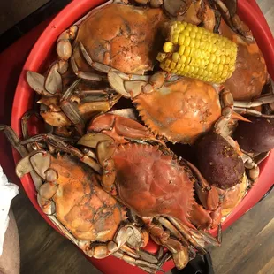 a bowl of crabs and corn