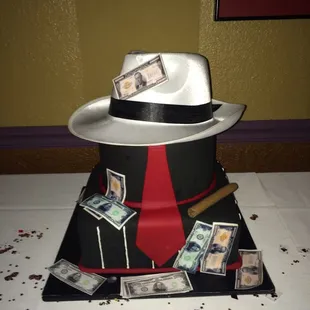 a top hat with money and a cigar