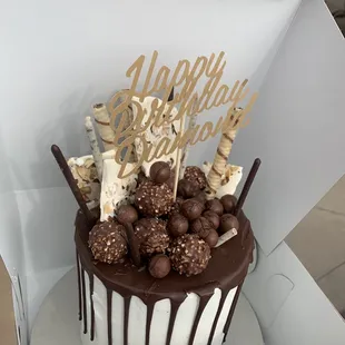 a birthday cake with chocolate drips