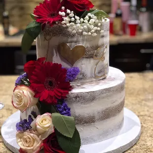 My friends' cake (the florals were placed by us). They made this one too big but they didn't charge her for it.
