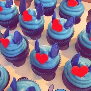 a box of cupcakes with blue frosting