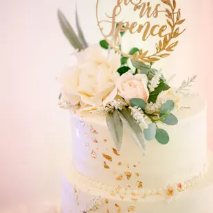 a wedding cake decorated with flowers