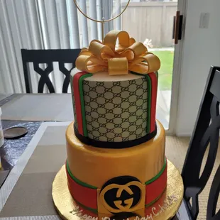 Glambam cake, using fondant and wdible images as well as a gumpaste airbrushed bow on top.