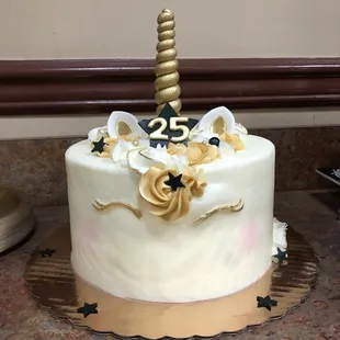 a white cake with a gold horn