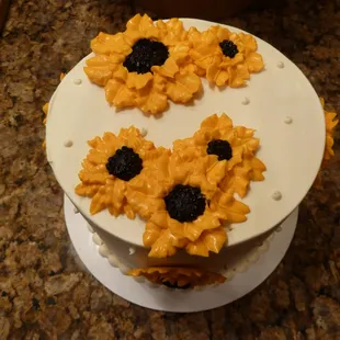 Small Carmel Cake w/White Chocolate Frosting w/sunflowers!...  this was around $25. 4 layers of yummy goodness.  Serves 6-8.