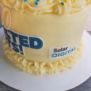 a yellow cake with white frosting and blue sprinkles