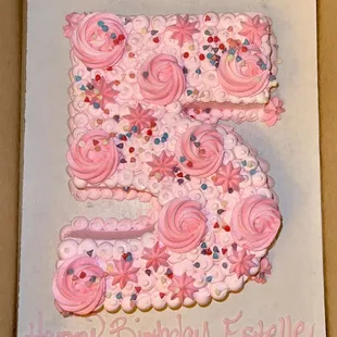 the number five with pink frosting and sprinkles