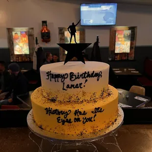 Two-tiered cake in "Hamilton" theme