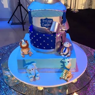 a blue and white cake with a crown on top