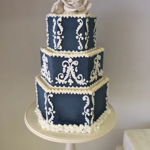 a three tiered blue and white cake