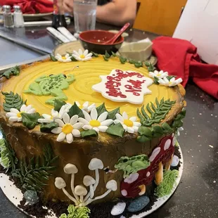 a man sitting in front of a cake
