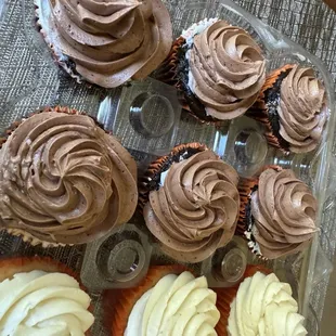 Chocolate cupcakes that were ordered with chocolate frosting, after they scraped the white frosting mistake off.