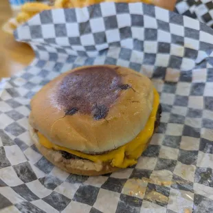 The kids meal burger: patty, cheese, spread and pickle