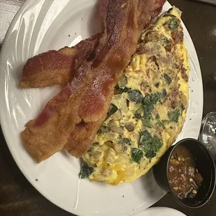 April 14, 2024 made to order omelette.  Spinach, onions, bacon, cheese and Salsa,