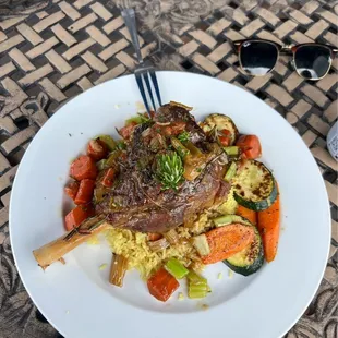 Mediterranean style leg of lamb with rice, zucchini, carrots and rosemary.