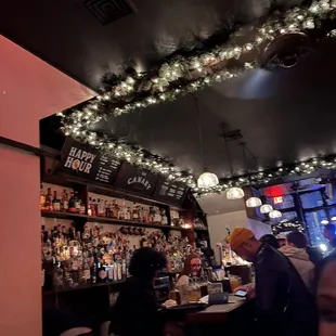 people sitting at a bar in a restaurant