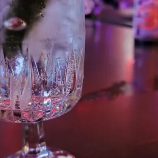 a close up of a glass with ice and a straw in it