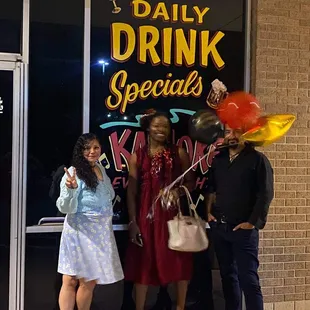 a group of people standing outside of a restaurant