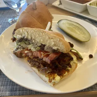 a sandwich on a plate with a pickle