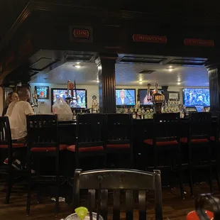 Dark bar with 5 TVs in view
