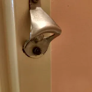 Was amused by this... a bottle opener screwed into the bathroom door frame!
