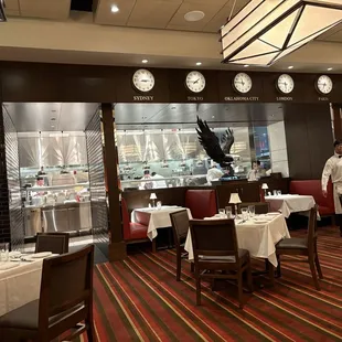 Main dining area facing the busy kitchen. Loves the clocks.