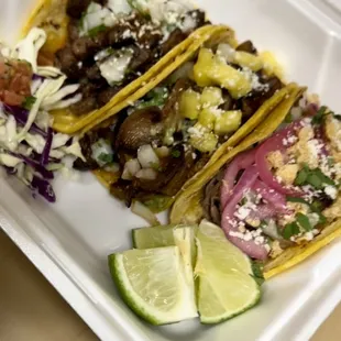 three tacos in a styrofoam container