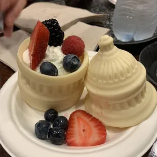 Capitol dessert. Berries in whipped cream inside a hollow white chocolate capitol. Cute, but I would skip this for a tastier dessert.
