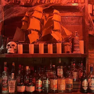 a shelf full of liquor bottles