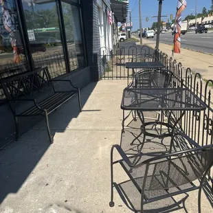 a row of chairs on the sidewalk