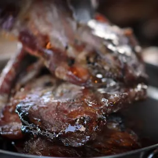 a steak being cooked in a pan