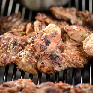 a bunch of meat on the grill