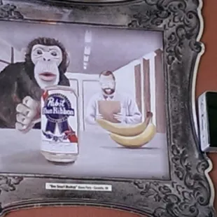 a monkey holding a can of beer