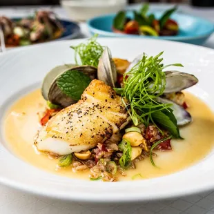 Seared Sea Bass with tom yum, littleneck clams, Hi-Fi mushroom, tomato confit, peanut