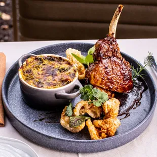 Heritage Pork Chop with charred broccoli- smoked cheddar casserole, ham hock, chicharron