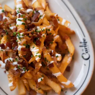 Loaded french fries topped with bacon and ranch dressing at The Carlile in Downtown Seattle