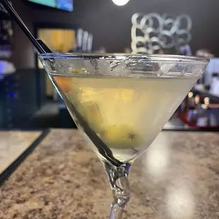 a martini glass with a lemon garnish
